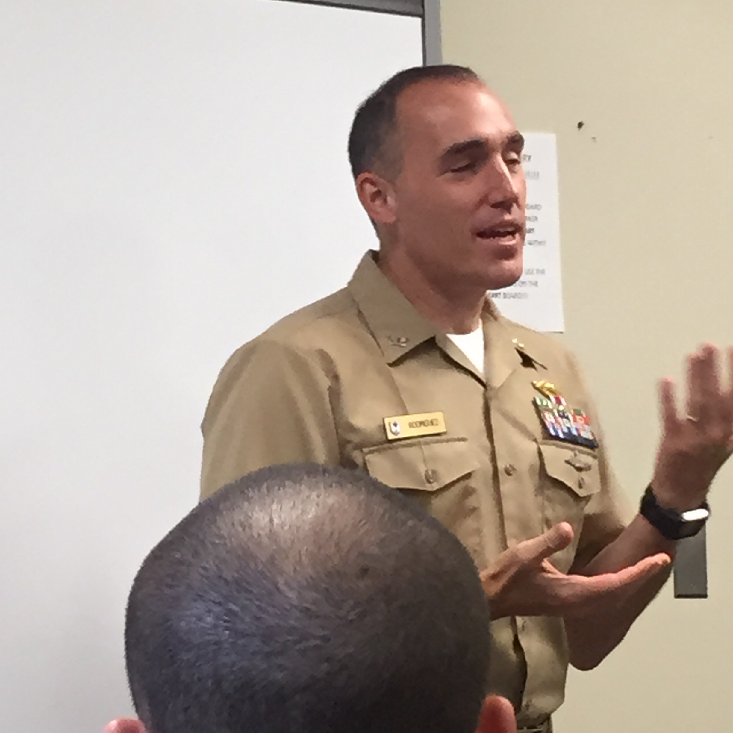 Dr. Rodriguez in Navy uniform speaking to an audience