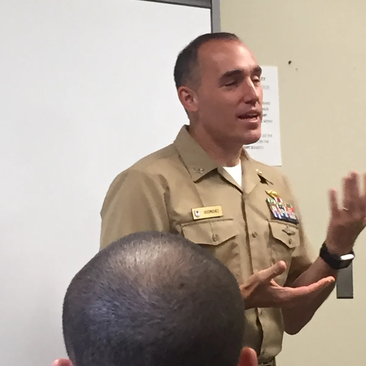 Dr. Rodriguez in Navy uniform speaking to an audience